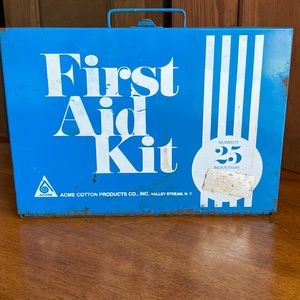 Vintage metal First Aid box with latch and handle.